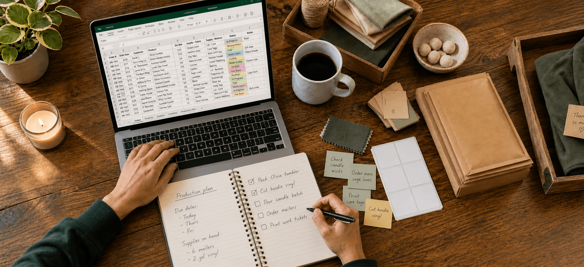 Overhead view of a maker juggling an order spreadsheet, handwritten production notebook, and sticky-note reminders